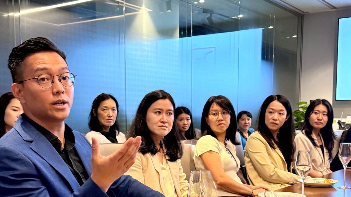 Paul Kam leading a live executive-presence role-play for senior women in asset management — Ladies Consultant Network Hong Kong, hosted by T. Rowe Price